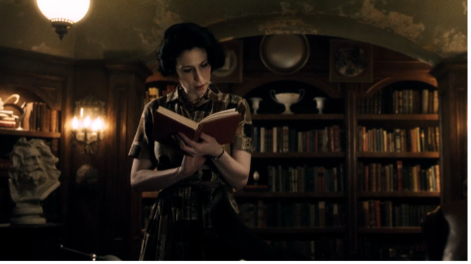 Jackie Loomis reading a book in the library at Lodge 49.
