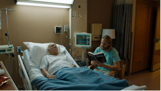 Dud reading to Larry Loomis in the hospital.