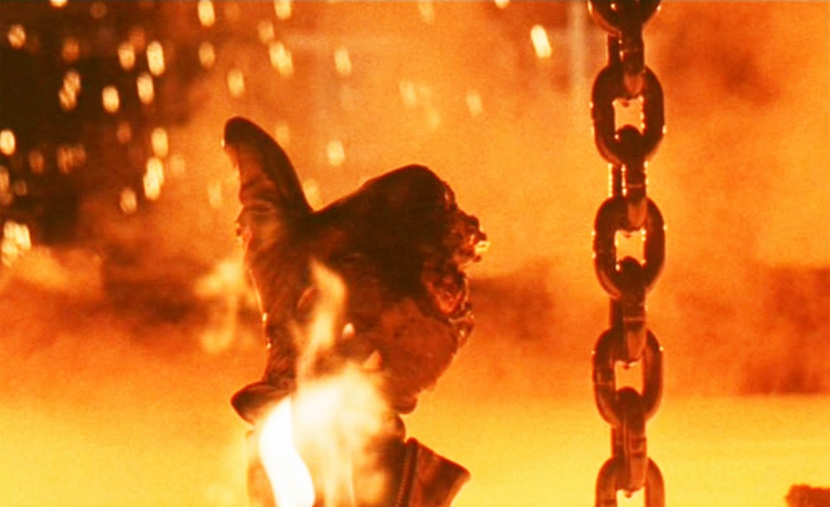 [Alt-Text: The gloved hand of the Terminator robot giving a thumbs up as it descends into a fiery cauldron of molten metal.]